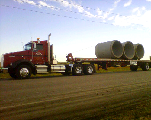 truck-transporting-concrete-pipe.png